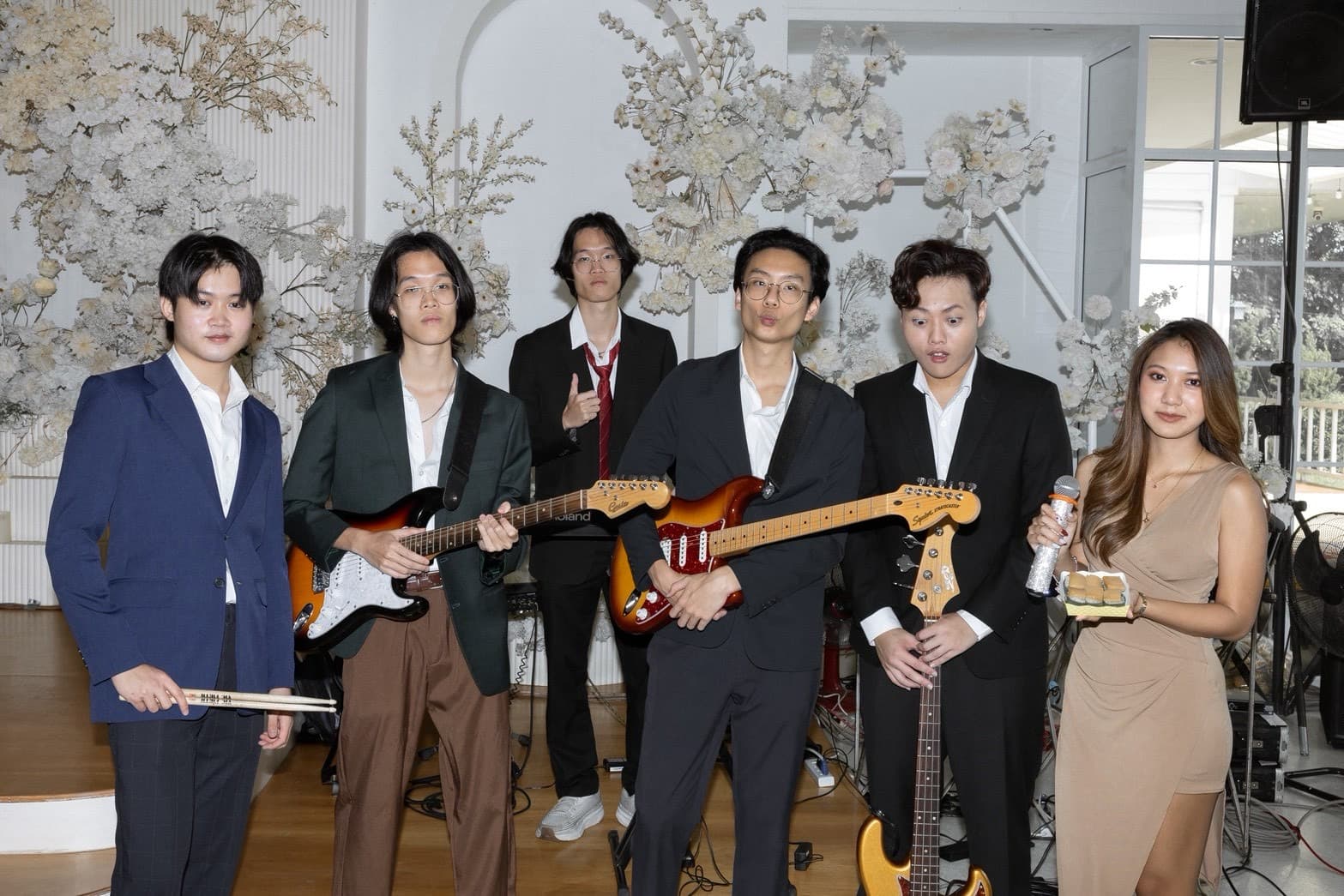 Band members and Vega after the congratulations set, still holding guitars and a microphone