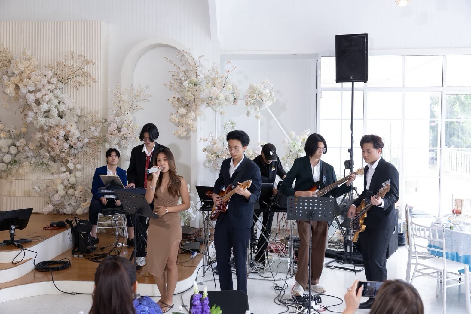 Vega Visara singing with a live band at the National Mother of the Year ceremony